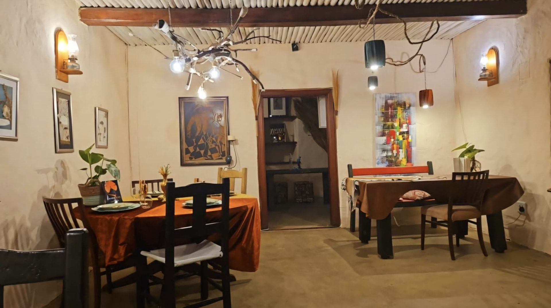 Candlelit dining room with African art at Afrikan Prominence